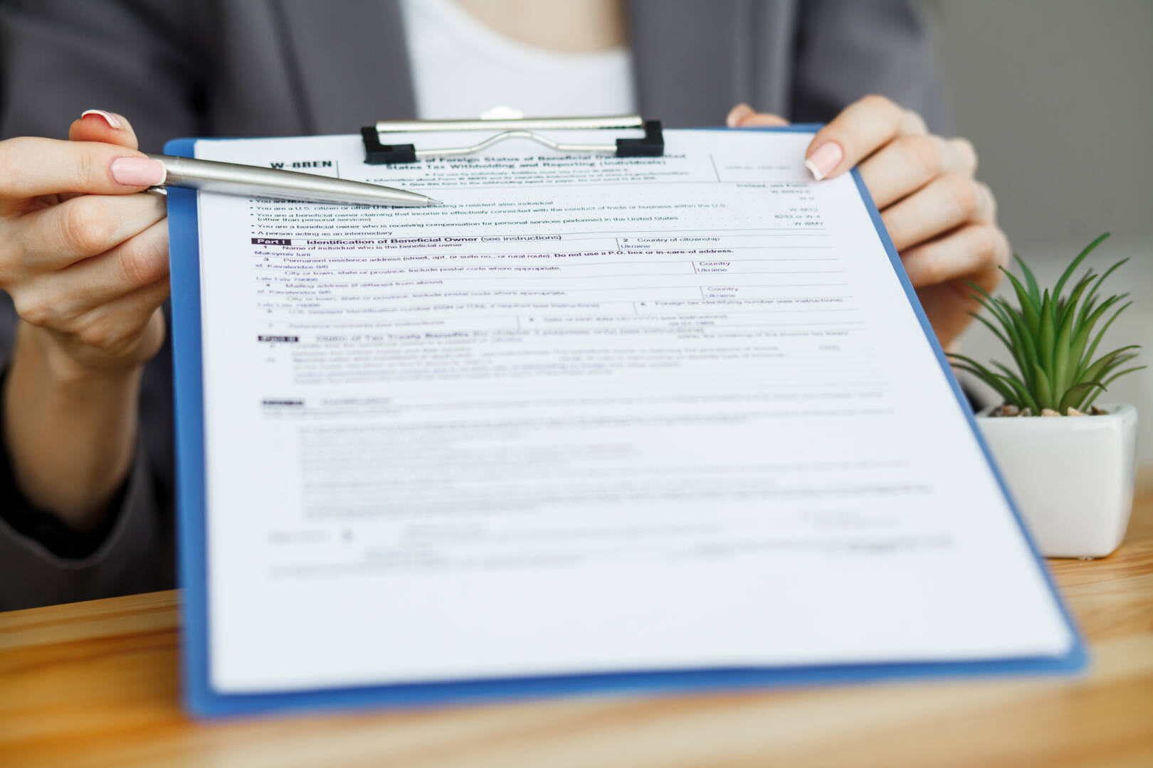 Woman hand writing or signing in a document